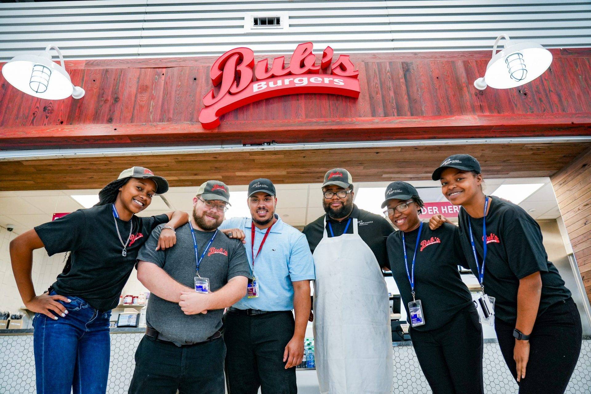 SSP America team members standing outside a Bub’s Burgers restaurant.